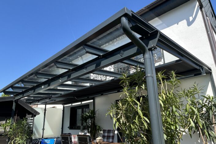 Terrassenüberdachung mit Glasdach und feingliedriger Stahlkonstruktion in anthrazit