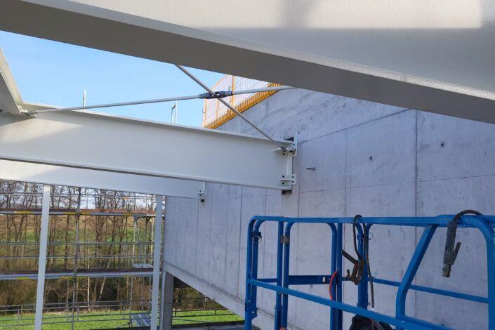 Detailaufnahme eines Stahlträgers mit F30-Brandschutzbeschichtung im Neubau einer Stahlhalle